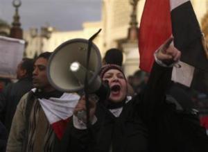 A protester uses a loudhailer as she chants anti-Mursi slogans during a protest in front of the presidential palace in Cairo